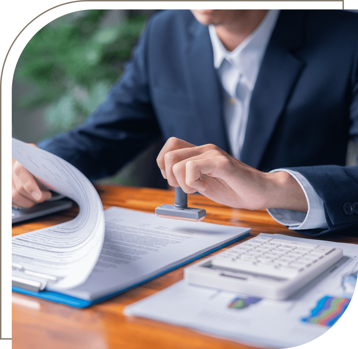 Man stamping documents at a desk.
