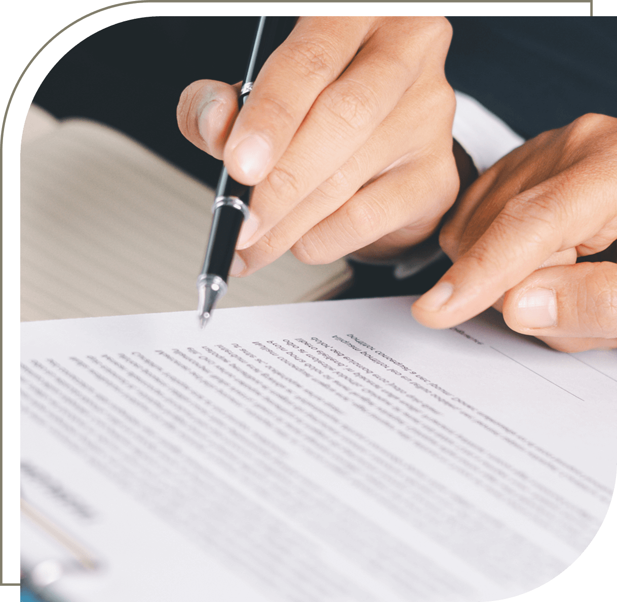 Hand signing a document with pen.