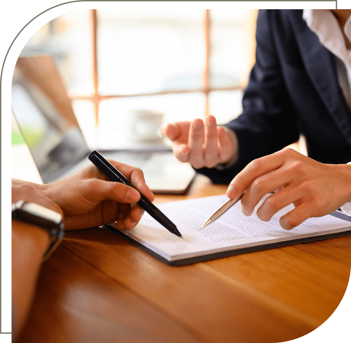 Two people discussing and signing a document.