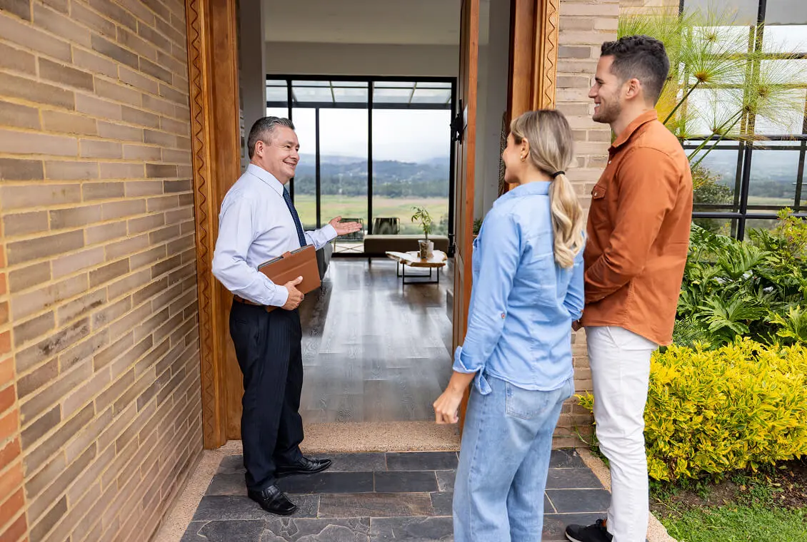Realtor showing couple a modern home.